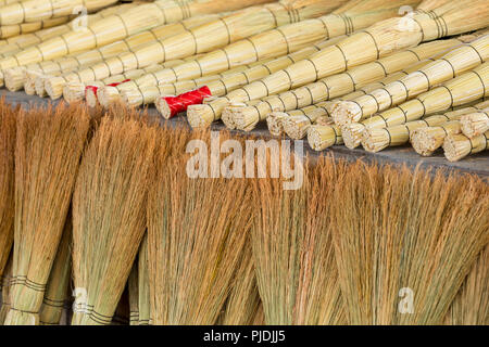 A pile of bamboo brooms in market for sale at Uzbekistan bazaar. Stock Photo