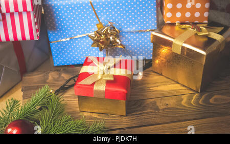 Closeup image of colorful Christmas gift boxes and present on wooden background Stock Photo