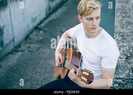 Young musician playing guitar Stock Photo