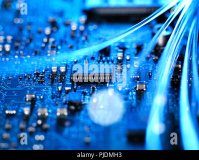 Fibre optics carrying data connecting to the circuit board of a laptop computer Stock Photo
