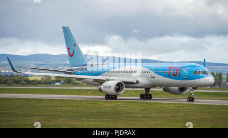 TUI Airlines Boeing 757 bound for sunny Spanish climates seen before taking off from Glasgow International Airport, Renfrewshire, Scotland. Stock Photo