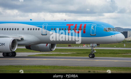 TUI Airlines Boeing 757 bound for sunny Spanish climates seen before taking off from Glasgow International Airport, Renfrewshire, Scotland. Stock Photo