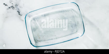 banner of Glass pan for baking on a marble table Stock Photo