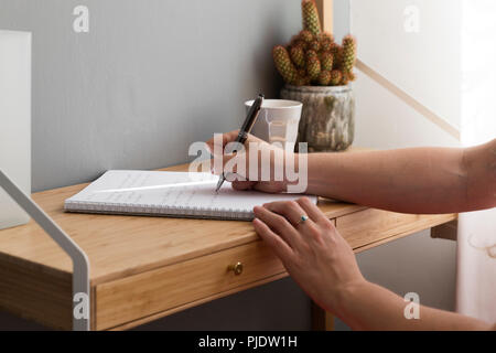 Handwritten note with coffee and cactus on desktop. Stock Photo