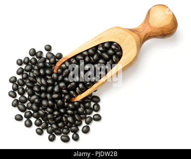 uncooked black beans in the wooden scoop, isolated on the white background, top view Stock Photo