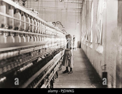 Sadie Pfeiffer, Spinner in a Cotton Mill.  Taken in Lancaster, North Carolina in 1908. After a photograph by Lewis Hine, 1874-1940.  Hine was a sociology teacher who used photography to record social problems and spur reform. Stock Photo