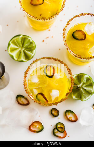 cocktail margarita of tequila, mango juice, hot pepper and lime on the table. bar accessories Stock Photo