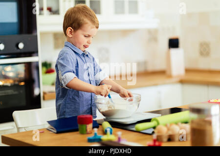 Cute child learning to become a chef Stock Photo