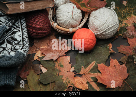 Knitting threads in a park on leaves Stock Photo