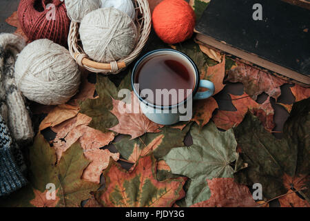 Knitting threads in a park on leaves Stock Photo