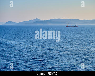 A Tanker crossing the Aegean sea with Greek coasts in the background. Attica region, Greece. Stock Photo