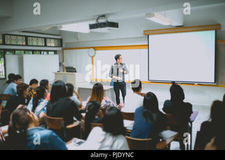 Teacher teaching studen in classroom at university. Stock Photo