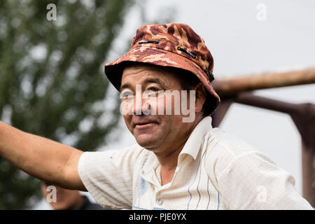 Karakol, Kyrgystan, August 13 2018: Portrait of a  Farrier on the weekly animal market in Karakol changes horses' horseshoes Stock Photo