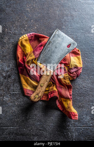 Old meat butcher on dark concrete board. Stock Photo