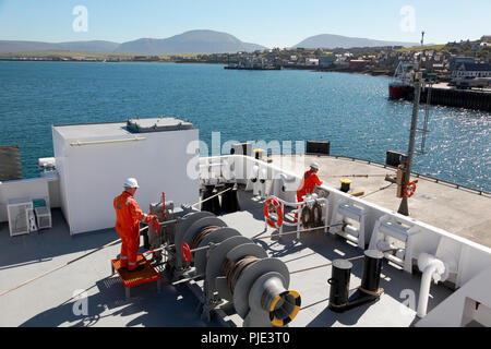 Weighing anchor on the rear deck of the car ferry Hamnavoe, Stromness, Orkney, the hills of Hoy in the distance Stock Photo