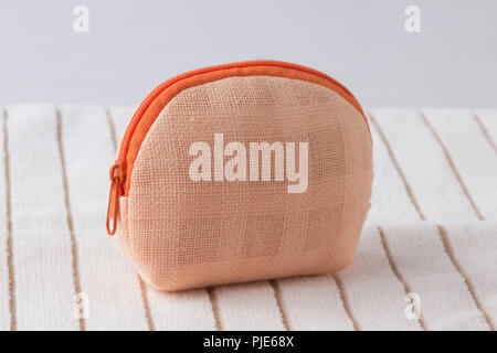 Fabric purse for coins on white cloth background Stock Photo