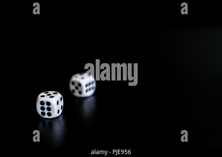 monochrome dice at the casino on a black background the result is 6. Stock Photo