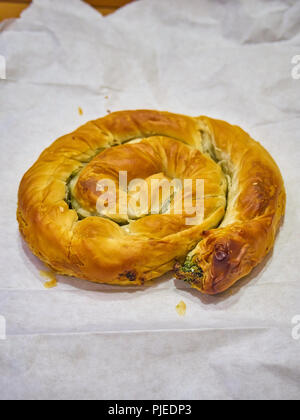 A traditional Spanakotiropita, Spinach and Feta cheese pie, typical greek street food. Stock Photo