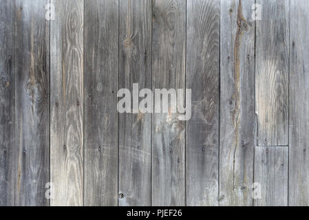 Unpainted gray wooden door consisting of old weathered unpainted boards Stock Photo