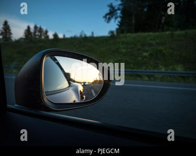 Rearview Mirror with sunset in background Stock Photo