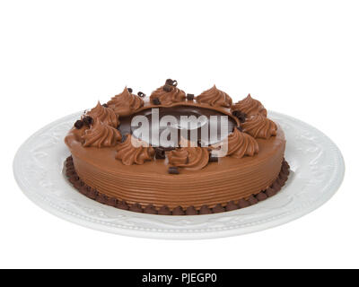 Home made chocolate cake with chocolate fudge on top on an off white porcelain plate isolated on white background. Stock Photo
