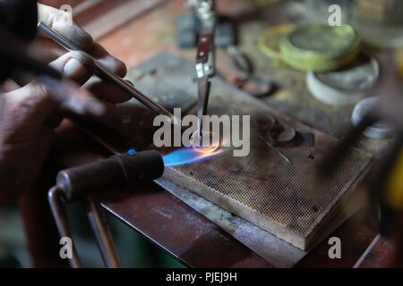 Work of the master, jeweler. Jewelry repair shop. Manufacturing of jewelry. Stock Photo