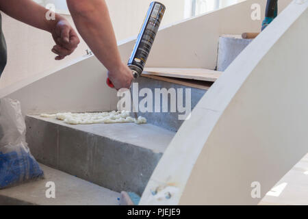 Worker is using a polyurethane foam for installation of window sill Stock  Photo - Alamy