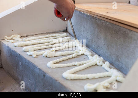Production and installation of flax. Work of the master. Stock Photo