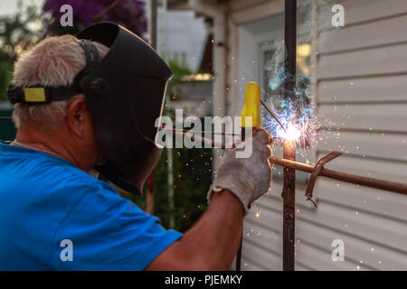 Worker summer worker works with welding on site Stock Photo