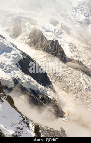 Winter snow covered mountain rock close up, natural background and texture Stock Photo