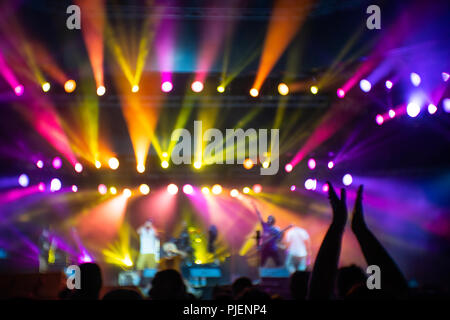Abstraction with blurry musicians on stage full of colorful stage lights during the concert Stock Photo