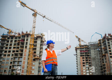 Architect showing buildings on a construction site during a housing project Stock Photo