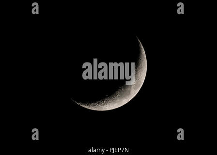 Waxing Crescent moon, 4 days old, in the night sky. New moon. Young moon. Stock Photo