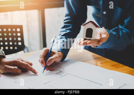 Architect or engineer using pen working on blueprint, architectural concept Stock Photo