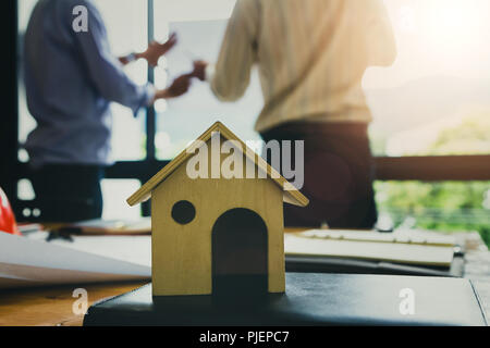 A architects house model with plan and blueprints Stock Photo