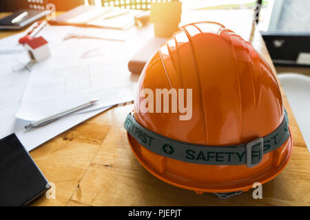 Helmet and etc. on desk in office, architectural concept Stock Photo
