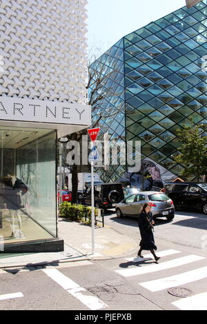 View of Aoyama's Stella McCartney with the futuristic green glass Herzog and de Meuron-designed Prada store across the street. Stock Photo