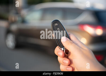 Man opening car with the control remote key. Keyless car system remote control Stock Photo