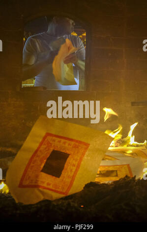 Kuala Lumpur, Klang, Malaysia. 26th Aug, 2018. A man seen burning the hell money during the hungry ghost festival at a temple in Klang.Hungry ghost festival were celebrated at Malaysia on the 7th month of Chinese calendar by the Buddhist, Taoist and also since the Chinese ancient religion has believe the gate of hell will be open for the hungry ghost to seek food an entertainment on the world. According to their understanding the hungry ghost can emerge from neglect or desertion of ancestor and also from the violent and unhappy death. Usually the devotee families will offer prayers to the Stock Photo