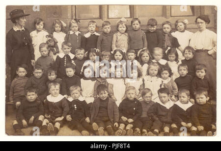 Early 1900's postcard of infant class outside primary school with teachers - WW1 period, circa 1915, U.K Stock Photo