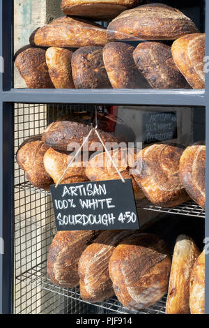 Sourdough bread for sale in a shop window. Burford, Cotswols, Oxfordshire, England Stock Photo