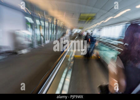 Passengers on moving walkway converging to aircraft - Toronto airport Stock Photo