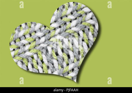 knitted heart, light green, gray and white, isolated on light green background Stock Photo