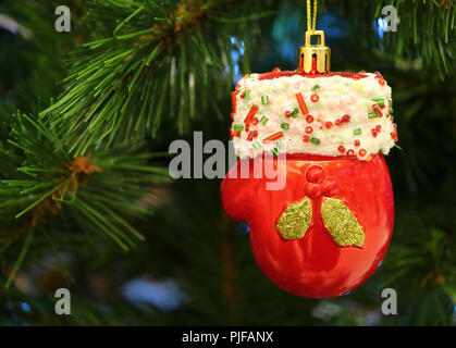 Mini Santa Claus Red Glove Ceramic Ornament Hanging on the Christmas Tree Stock Photo