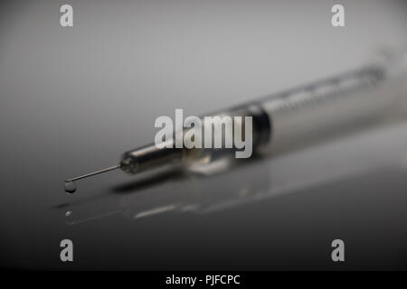 Intravenous Drug injection needle. Close up of a syringe on a white background. Flue Vaccine. Stock Photo