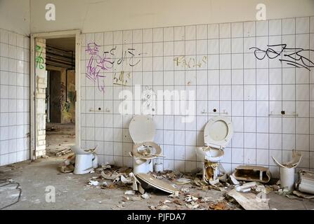 Toilets in an abandoned empty factory in Magdeburg Stock Photo