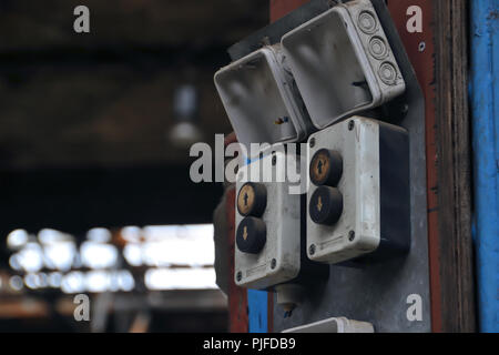 Buttons for operating a crane in an abandoned disused factory in Magdeburg Stock Photo