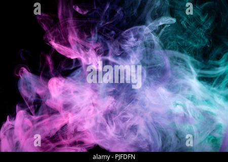 Thick colorful smoke of pink, blue and green on a black isolated background. Background from the smoke of vape Stock Photo