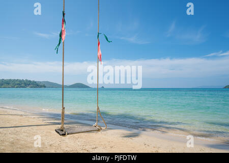 Swing hang from coconut palm tree over summer beach sea in Phuket ,Thailand. Summer, Travel, Vacation and Holiday concept Stock Photo