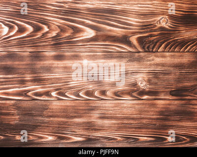 Wooden background from wood pine burnt paint brush abstract texture annual rings places knots prefabricated boards for covering parquet laminate pictu Stock Photo